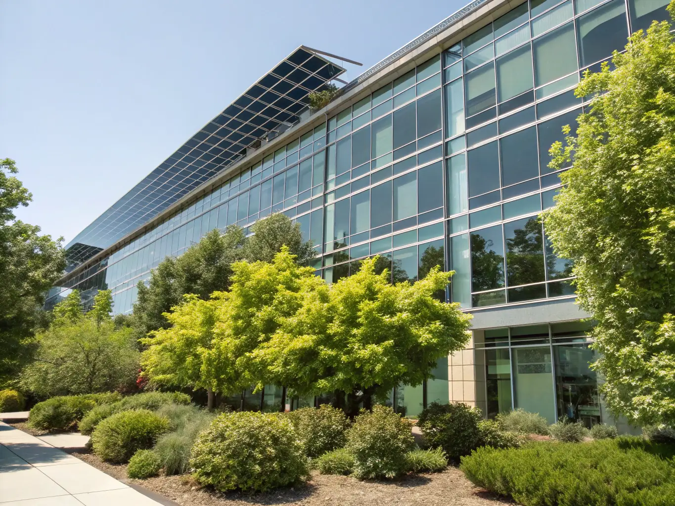A modern office building with glass facade reflecting the sky, symbolizing investment in prime commercial real estate.